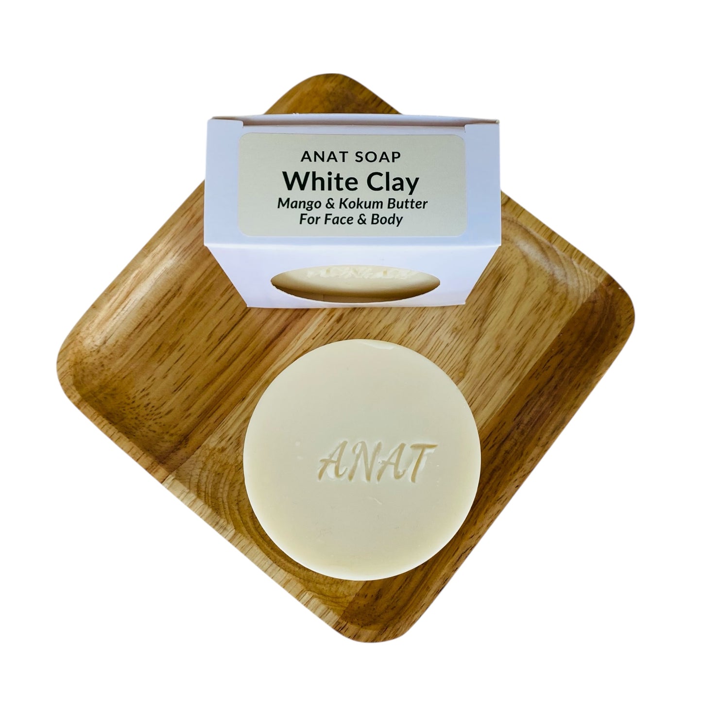 Anat Soap White Clay round handmade plant-based soap bar with mango and kokum butters for face and body, shown on a bamboo soap dish next to the product box.
