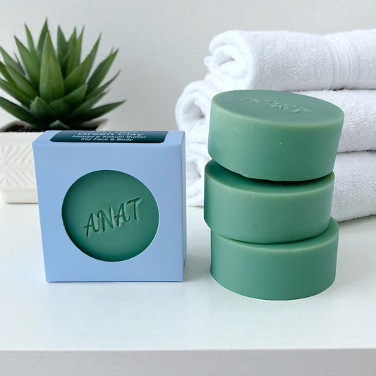 Anat Soap Green Clay round handmade plant-based soap bar with mango and kokum butters for face and body, shown next to the product box.