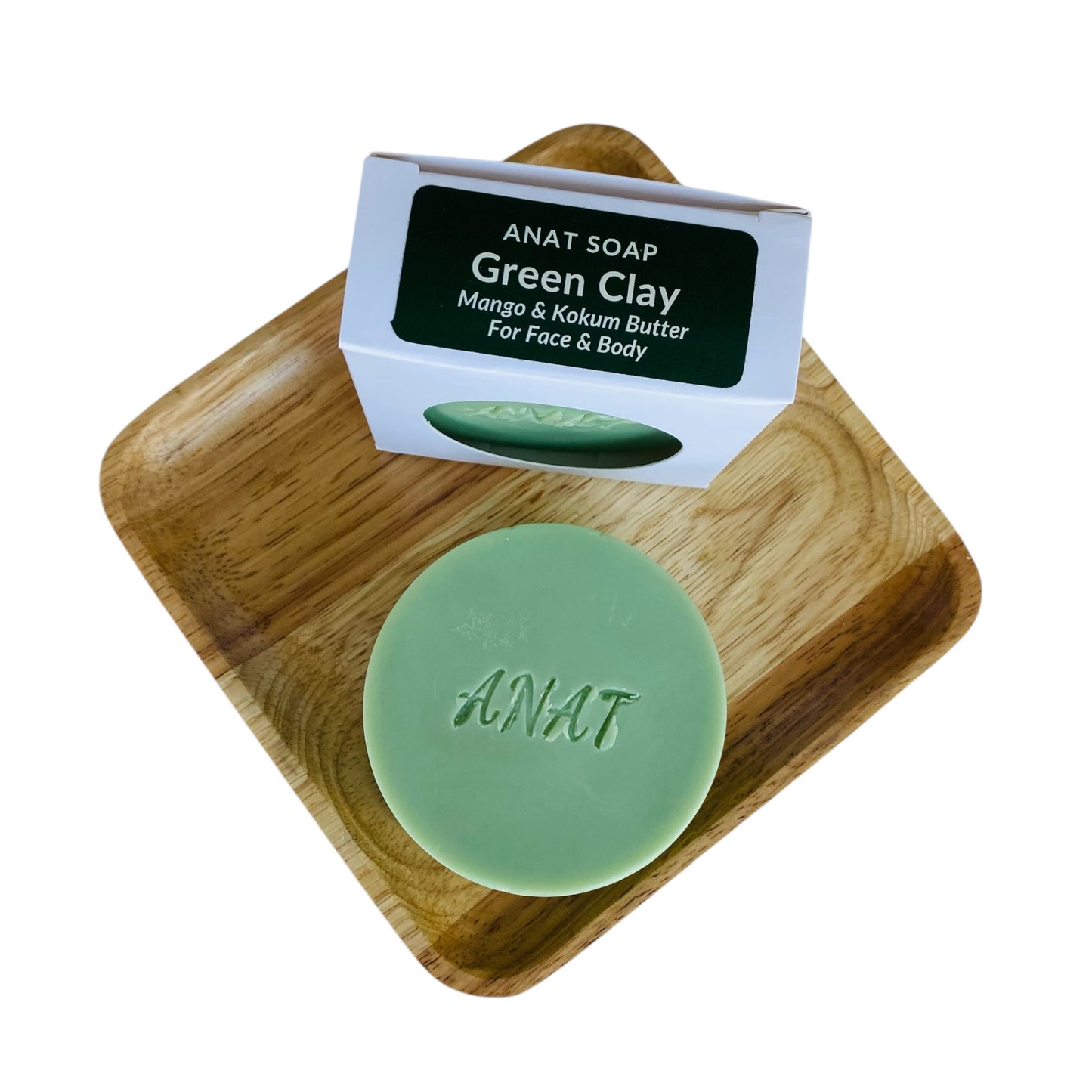 Anat Soap Green Clay round handmade plant-based soap bar with mango and kokum butters for face and body, shown on a bamboo soap dish next to the product box.