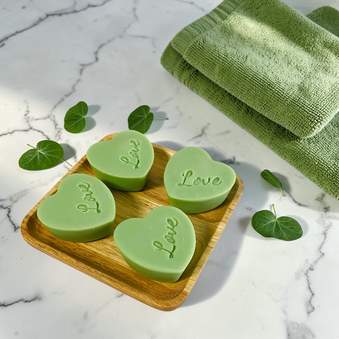 Green clay mini heart soap set on wooden tray with towel, handmade fragrance-free soap