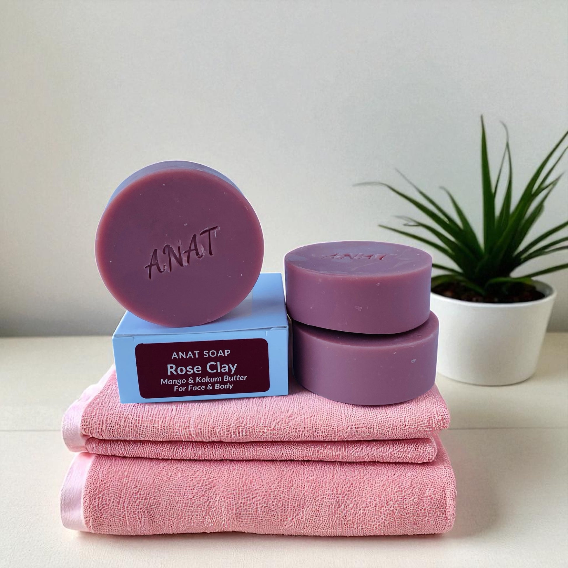 Anat Soap Rose Clay round handmade plant-based soap bar with mango and kokum butters for face and body, shown next to the product box.